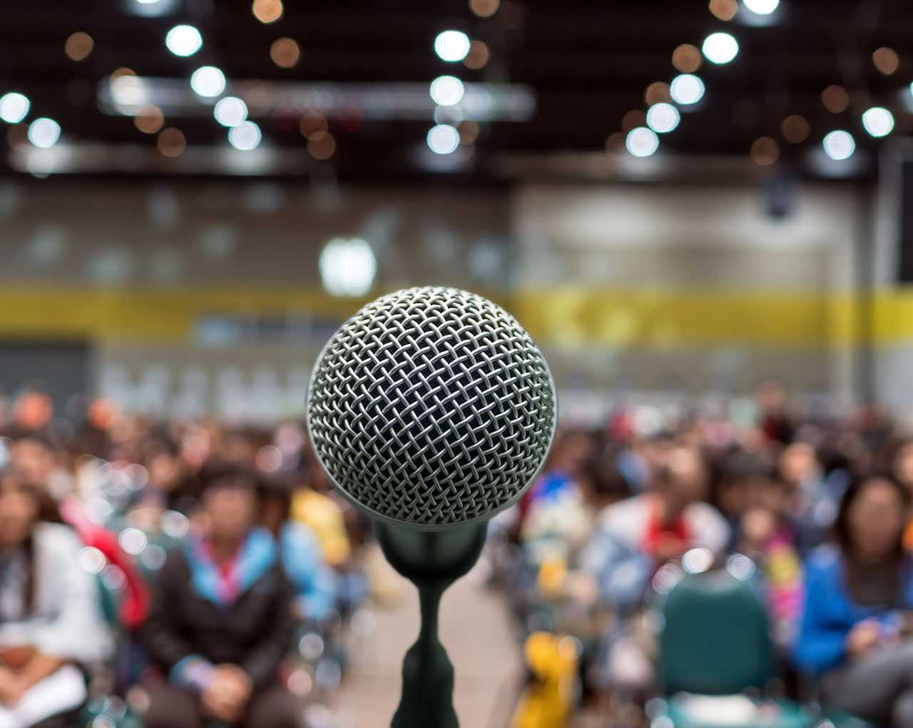 Microphone in front of room full of people